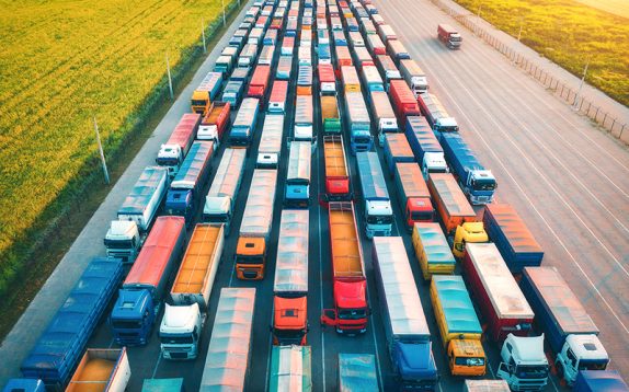 aerial-view-of-colorful-trucks-in-terminal-at-sunr-2026-03-16-06-25-30-utc