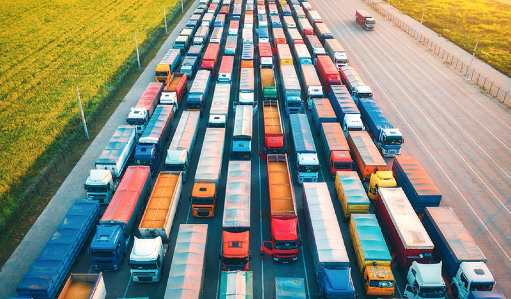 aerial-view-of-colorful-trucks-in-terminal-at-sunr-2026-03-16-06-25-30-utc